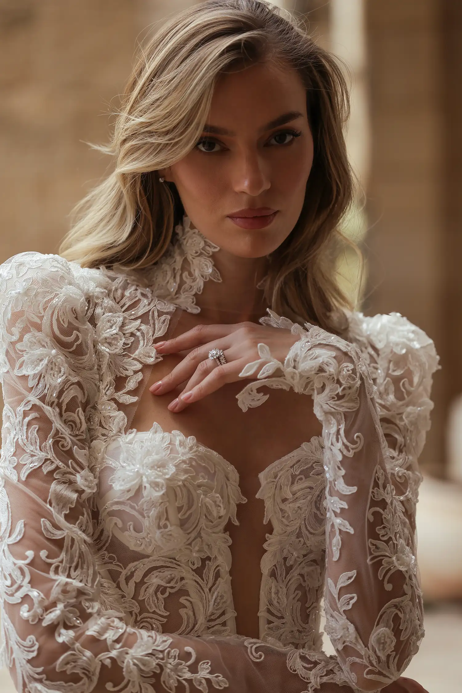 Beaded, dimensional flower embroidered boroque lace and silk organza ballgown, with tiered cutout skirt, high collar, and long puff sleeves. Shown with cathedral-length mantilla veil with beaded dimensional floral appliqué. 