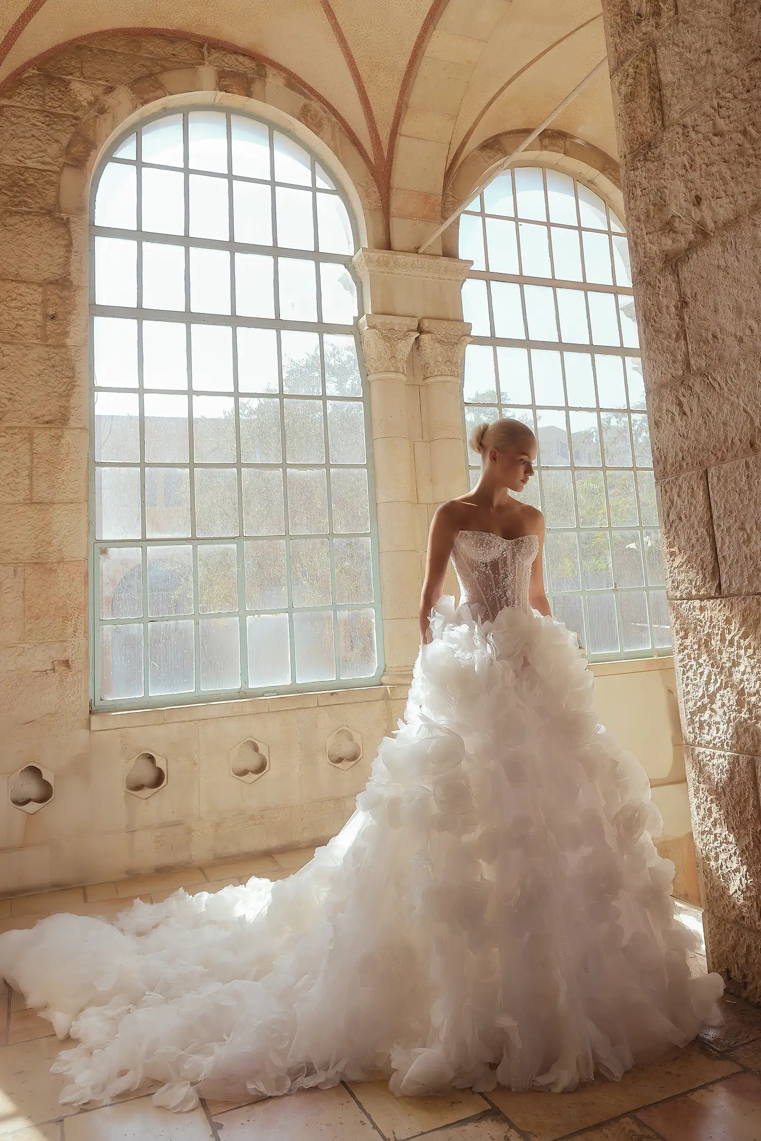 Strapless ballgown with hand-beaded chantilly lace corset with water crystal neckline detail and dimensional organza flower skirt.