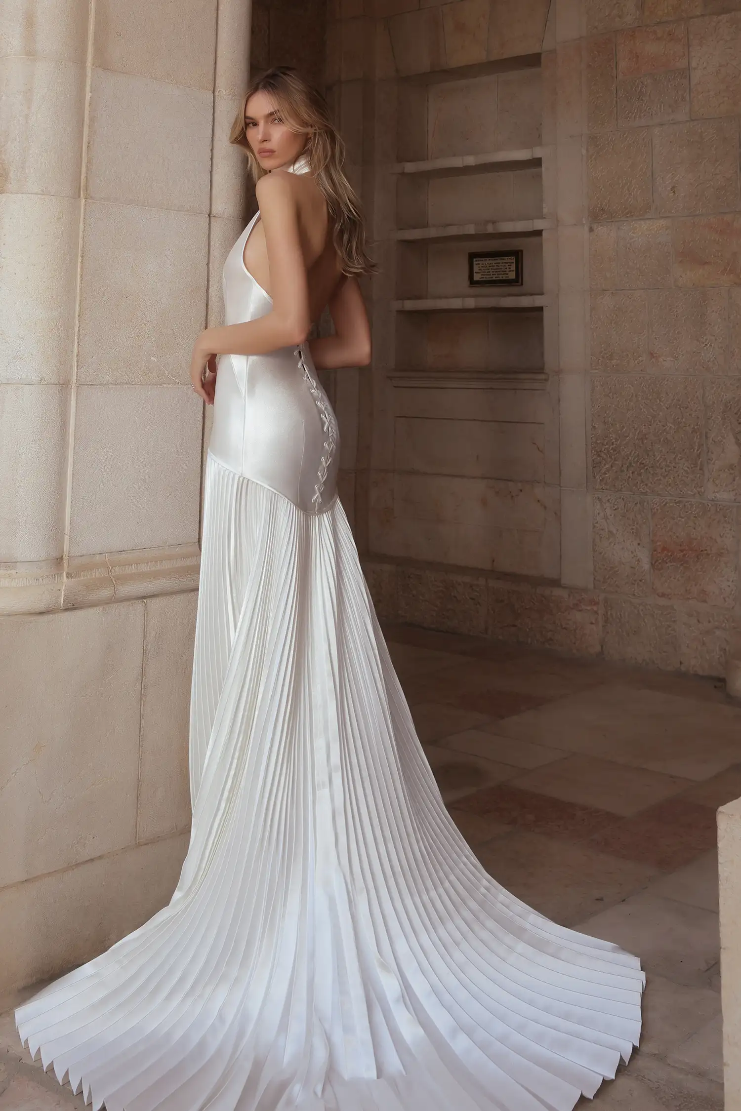 Doubleface satin halter gown with corset back and sunray pleated skirt, shown with stretch satin gloves.